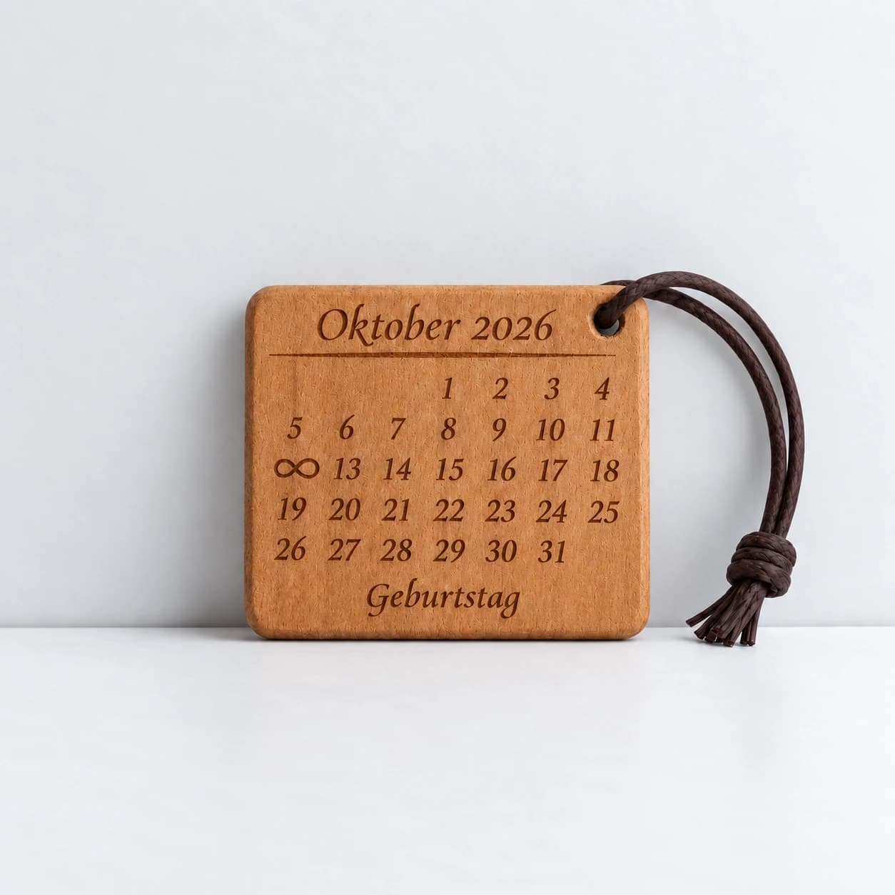 Kalender-Schlüsselanhänger mit Unendlichkeitszeichen zum Geburtstag – Produktansicht, Beispiel 12.10.2026