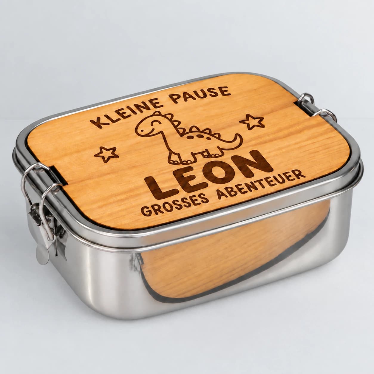 Personalisierte Edelstahl-Brotdose für Jungen mit Dino-Gravur und dem Namen Leon auf Holzdeckel